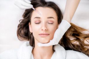 Woman receiving injection in her forehead